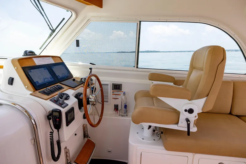 Slide: The Image of Helm of 2018 Back Cove Downeast 37 with navigation equipment and captain's chair. - 30