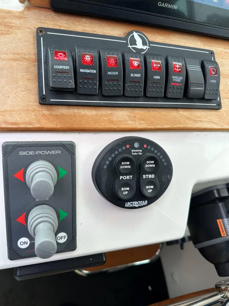Slide: The Image of Control panel of a 2018 Back Cove Downeast 37 boat with switches and dials. - 32