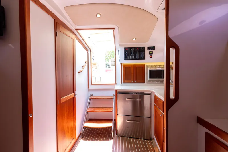Slide: The Image of Interior of 2018 Back Cove Downeast 37 yacht, featuring wooden cabinetry and modern appliances. - 33