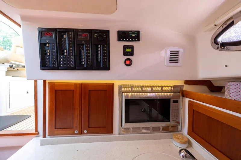 Slide: The Image of Control panel and kitchen area inside a 2018 Back Cove Downeast 37 boat. - 36