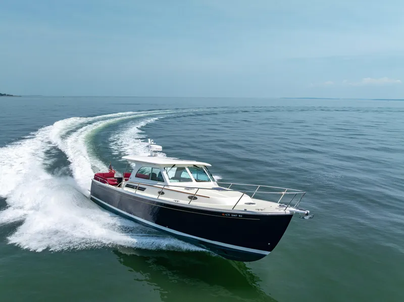 Slide: The Image of 2018 Back Cove Downeast 37 cruising on open water, creating a dynamic wake. - 4