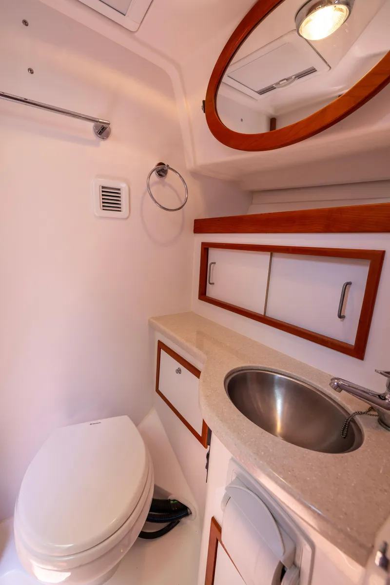 Slide: The Image of 2018 Back Cove Downeast 37 yacht bathroom with sink, toilet, and storage cabinets. - 43