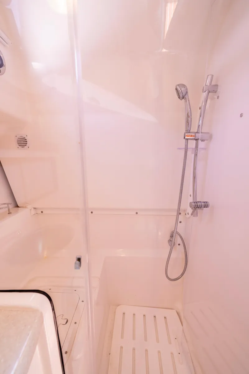 Slide: The Image of 2018 Back Cove Downeast 37 yacht shower area with handheld showerhead and white interior. - 44