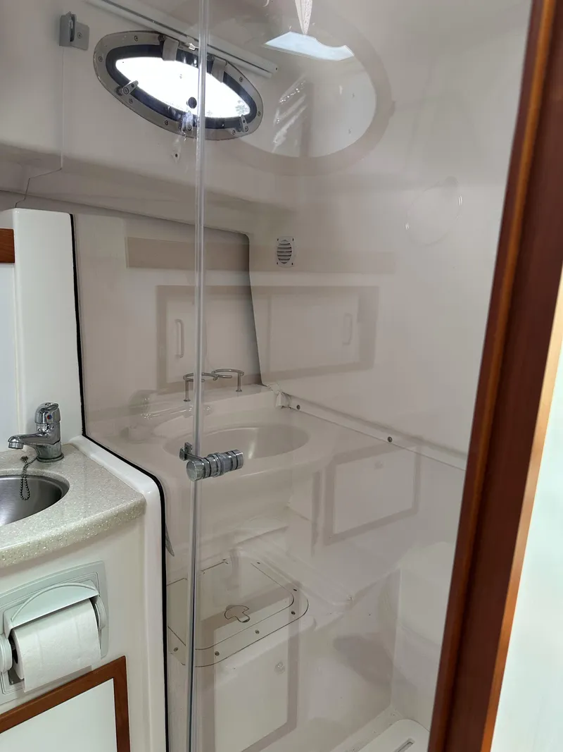 Slide: The Image of 2018 Back Cove Downeast 37 yacht bathroom with modern fixtures and porthole window. - 45