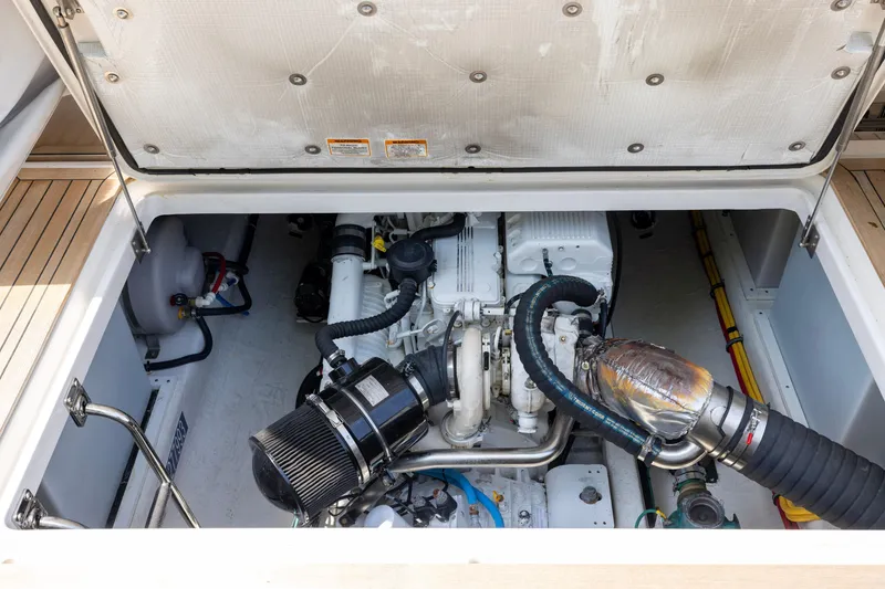 Slide: The Image of Engine compartment of a 2018 Back Cove Downeast 37 boat, showcasing mechanical components. - 47