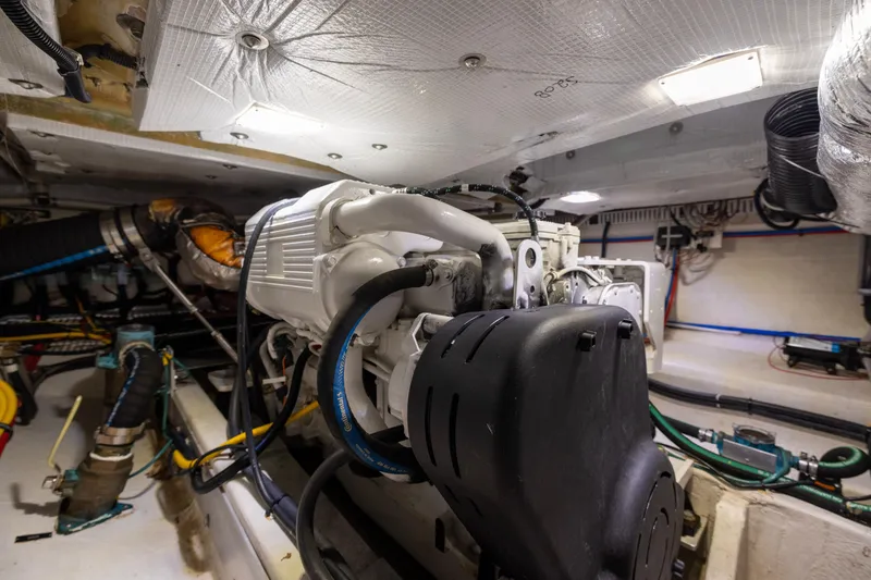 Slide: The Image of Engine room of 2018 Back Cove Downeast 37 boat, showcasing mechanical components and wiring. - 49