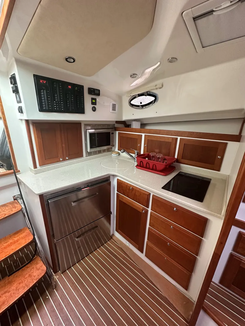 Slide: The Image of 2018 Back Cove Downeast 37 yacht kitchen with modern appliances and wood cabinetry. - 53
