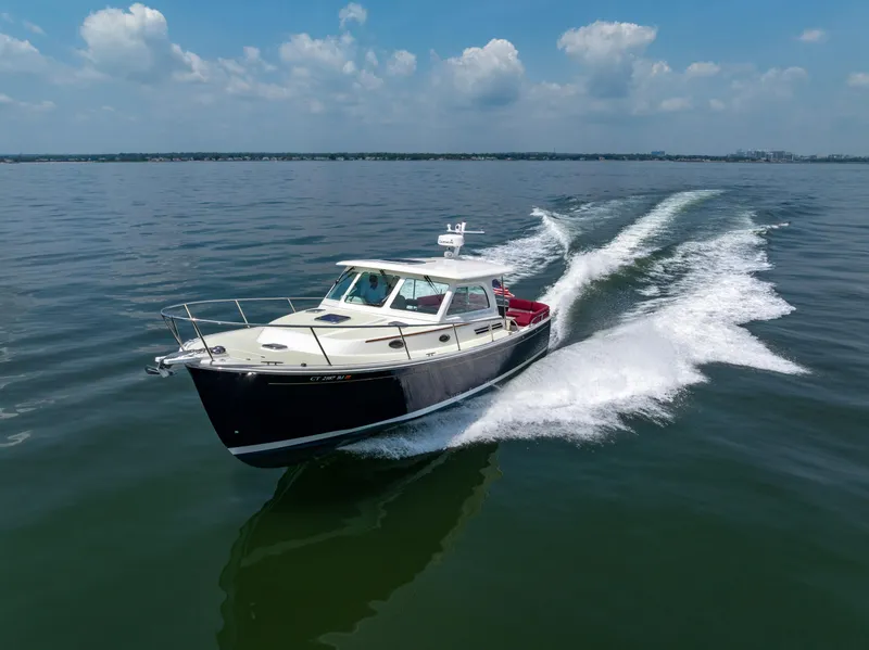 Slide: The Image of 2018 Back Cove Downeast 37 cruising on open water under a clear sky. - 7