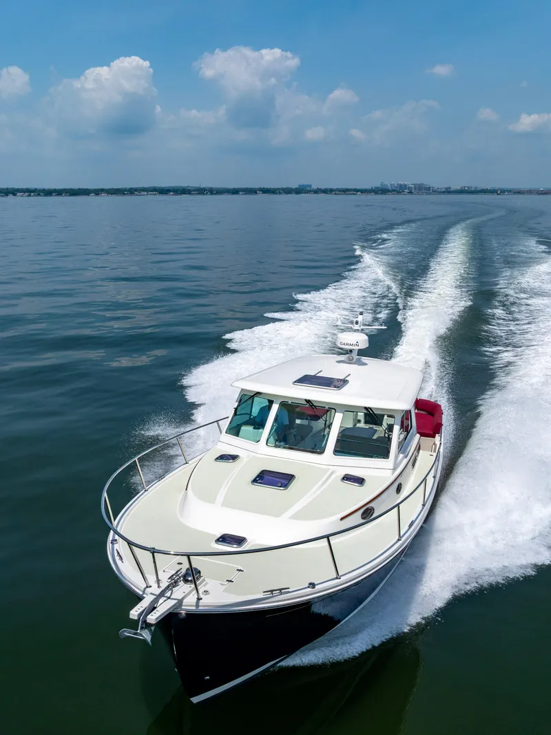 Slide: The Image of 2018 Back Cove Downeast 37 cruising on open water under a clear blue sky. - 8