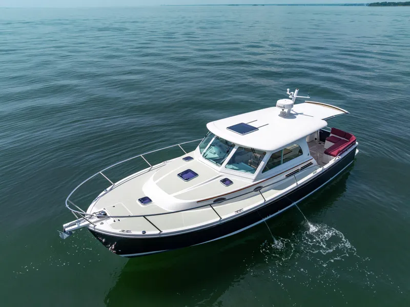 Slide: The Image of 2018 Back Cove Downeast 37 boat cruising on calm waters. - 9