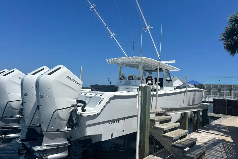 The Image of 2022 Freeman 47 boat cruising on open water with powerful Mercury engines. - 0