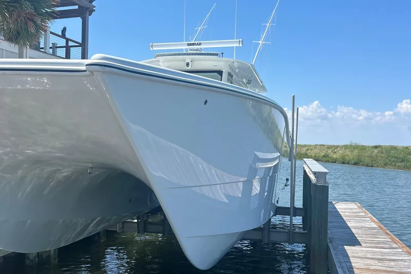 Slide: The Image of Freeman 47 boat, 2022 model, with quad engines on open water under blue sky. - 10
