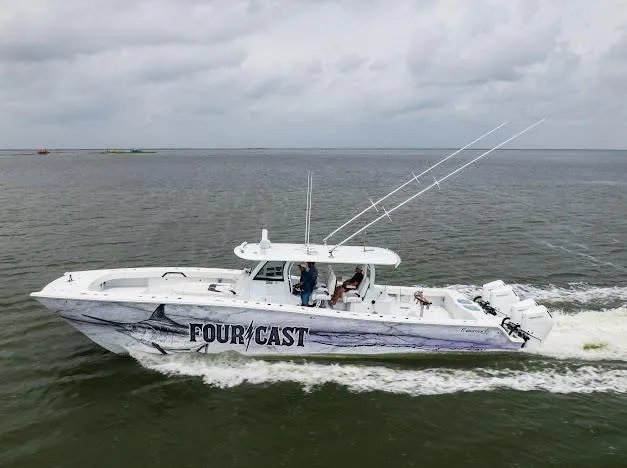 Slide: The Image of A 2022 Freeman 47 boat cruising on open water under a clear blue sky. - 11