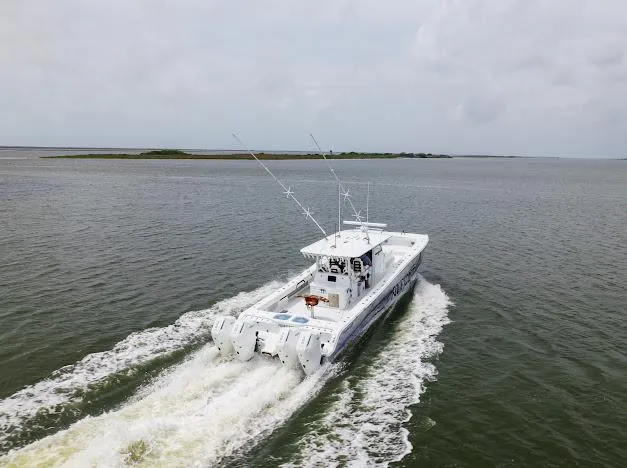 Slide: The Image of 2022 Freeman 47 boat cruising on open water under a partly cloudy sky. - 13