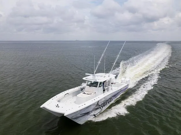 Slide: The Image of 2022 Freeman 47 boat docked by a waterfront building under a clear sky. - 15
