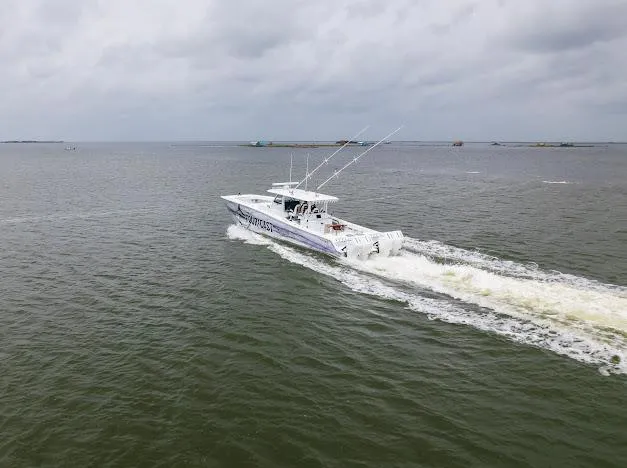 Slide: The Image of 2022 Freeman 47 boat docked, showcasing sleek design under a clear blue sky. - 16