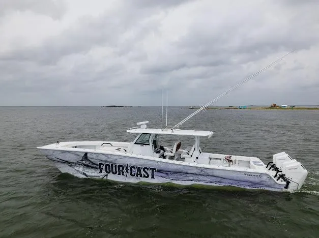 Slide: The Image of 2022 Freeman 47 boat docked, clear sky, calm water, person adjusting mooring line. - 19