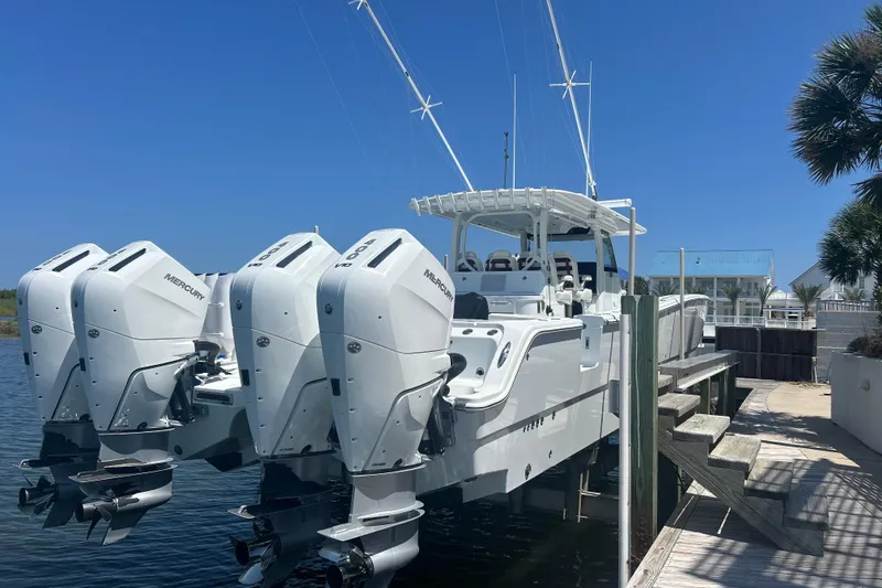 Slide: The Image of Freeman 47 boat on water, 2022 model, under clear blue sky with clouds. - 2