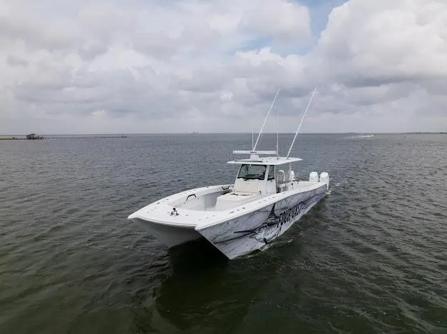 Slide: The Image of 2022 Freeman 47 boat on calm water under a blue sky with clouds. - 20