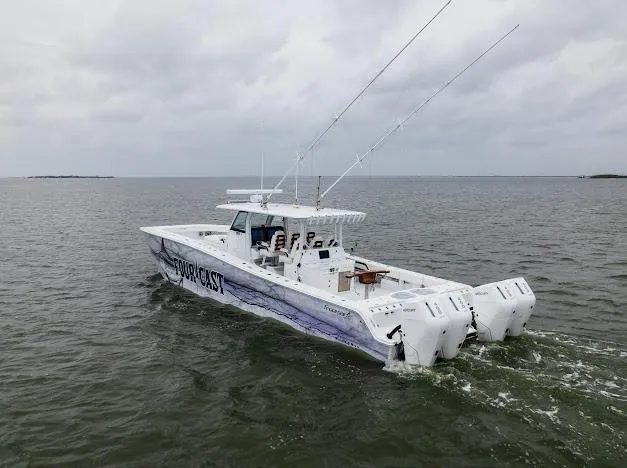 Slide: The Image of 2022 Freeman 47 boat cruising on a calm waterway under a partly cloudy sky. - 22