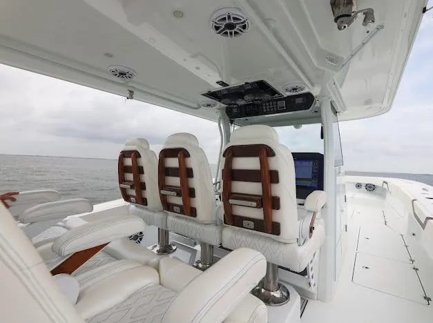 Slide: The Image of 2022 Freeman 47 boat with four engines on open water under cloudy sky. - 26