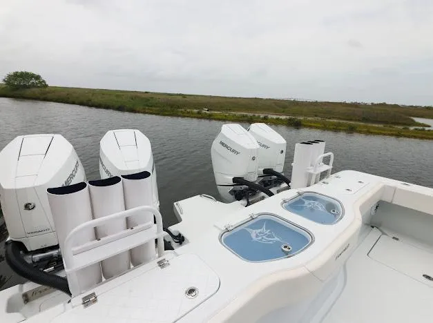 Slide: The Image of 2022 Freeman 47 boat interior with helm, ocean view, and fishing rod holders. - 27