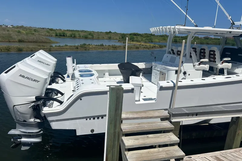 Slide: The Image of 2022 Freeman 47 boat cruising on open water under a clear blue sky. - 3