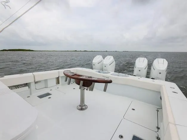 Slide: The Image of Freeman 47 boat, 2022 model, featuring dual Mercury engines and stylish glass doors. - 31