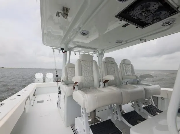 Slide: The Image of Twin Mercury outboard engines on a 2022 Freeman 47 boat, featuring rod holders. - 33