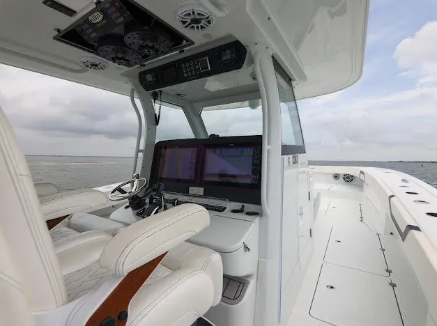 Slide: The Image of 2022 Freeman 47 boat deck with four engines, overlooking calm waters. - 34