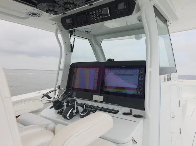 Slide: The Image of Luxury seating on a 2022 Freeman 47 boat, featuring plush white chairs and ocean backdrop. - 36