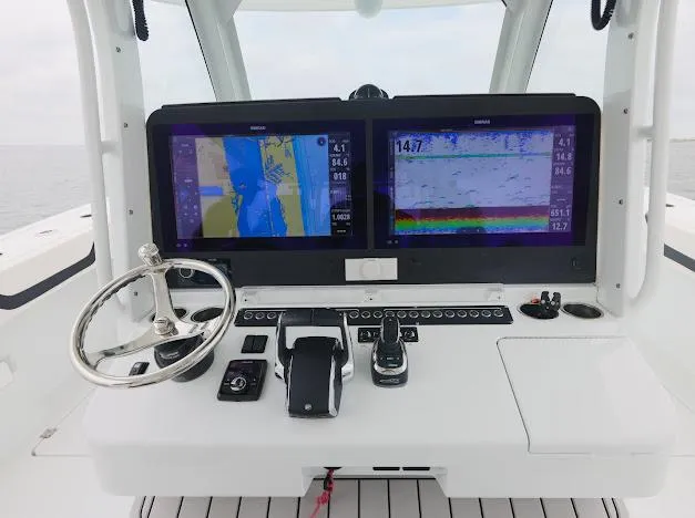 Slide: The Image of 2022 Freeman 47 boat cockpit with advanced navigation screens and controls. - 39
