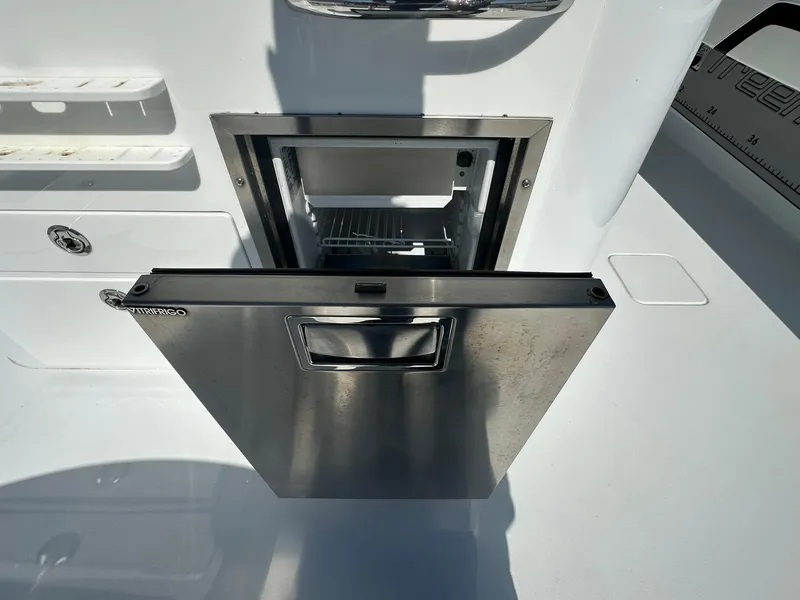 Slide: The Image of Freeman 47 boat dashboard with dual navigation screens and steering wheel, 2022 model. - 42