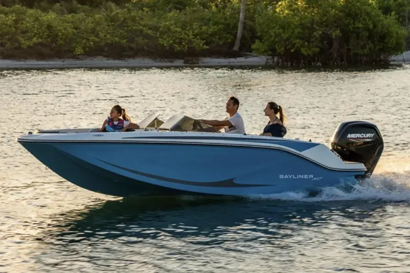 The Image of 2025 Bayliner Element M17 boat on trailer, parked outdoors with trees in background. - 0