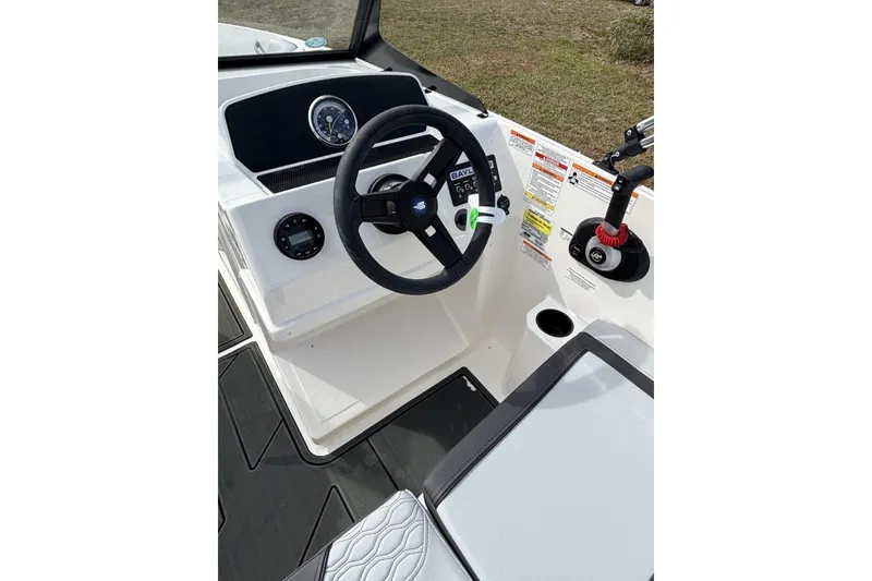 Slide: The Image of 2025 Bayliner Element M17 boat interior with seating and storage compartment. - 12