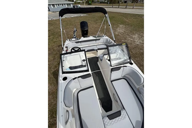 Slide: The Image of 2025 Bayliner Element M17 boat dashboard with steering wheel and controls. - 20