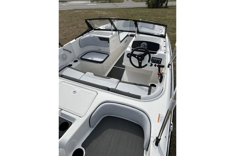 Slide: The Image of 2025 Bayliner Element M17 boat interior with modern seating and steering console. - 9