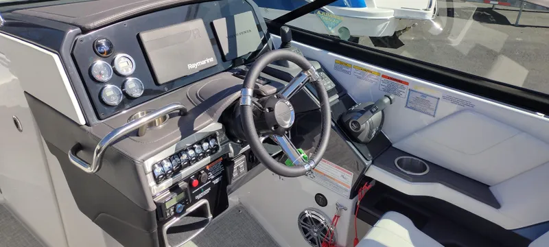Slide: The Image of 2024 Formula 290 BR boat dashboard with steering wheel and control panel. - 14