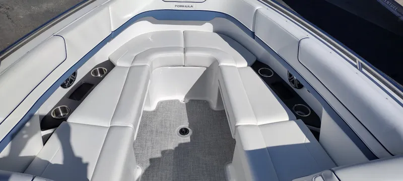 Slide: The Image of 2024 Formula 290 BR boat interior with white seating and cup holders. - 15