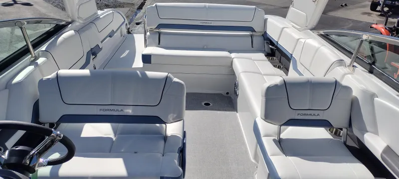 Slide: The Image of 2024 Formula 290 BR boat interior with white seating and modern design. - 16