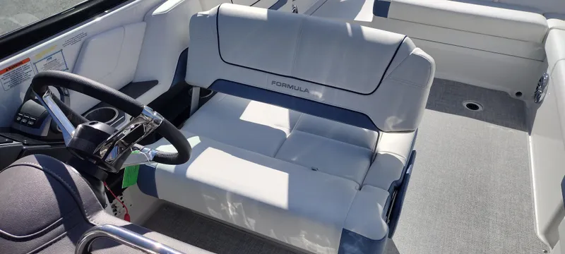 Slide: The Image of 2024 Formula 290 BR boat interior with steering wheel and seating. - 17