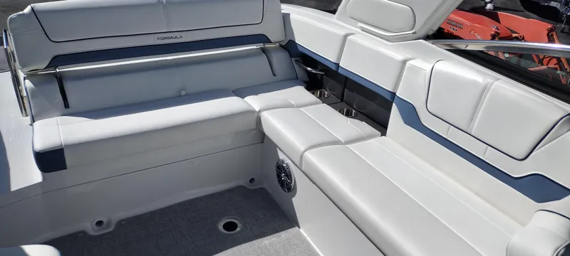 Slide: The Image of 2024 Formula 290 BR boat interior with white seating and blue accents. - 19