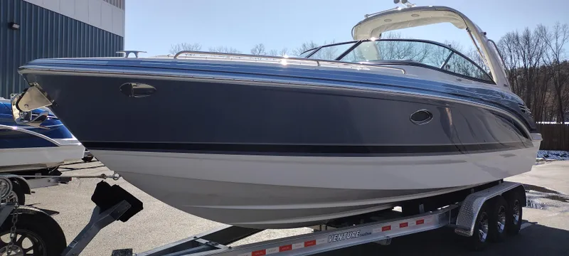 Slide: The Image of 2024 Formula 290 BR boat on trailer, sleek design, blue and white exterior. - 4