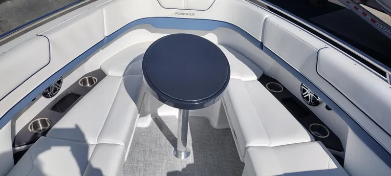 Slide: The Image of 2024 Formula 290 BR boat interior with white seating and central table. - 40