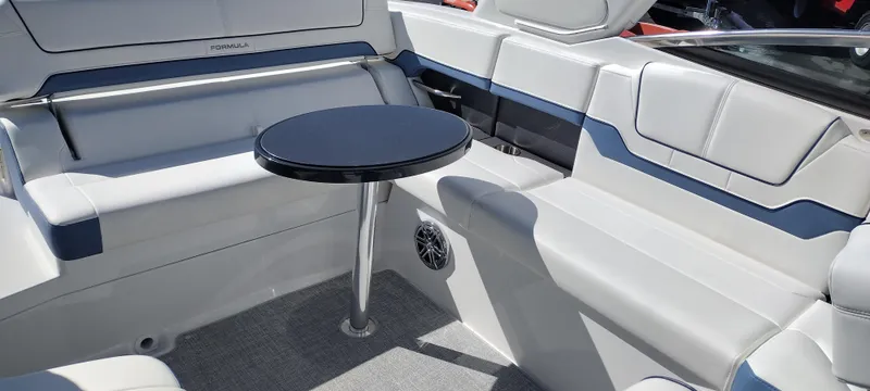 Slide: The Image of 2024 Formula 290 BR boat interior with seating and a small table. - 42