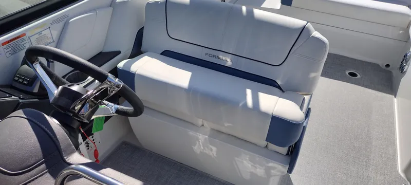Slide: The Image of 2024 Formula 290 BR boat interior with steering wheel and cushioned seating. - 43