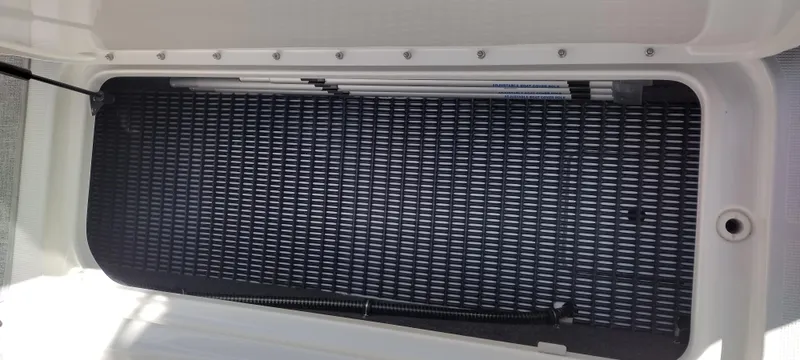 Slide: The Image of Storage compartment of 2024 Formula 290 BR boat, featuring a textured mat and secure fittings. - 44