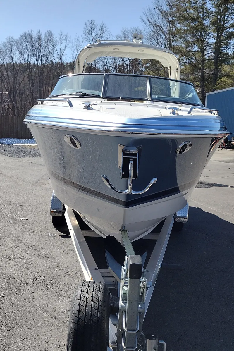 Slide: The Image of 2024 Formula 290 BR boat on trailer, parked outdoors on a sunny day. - 49