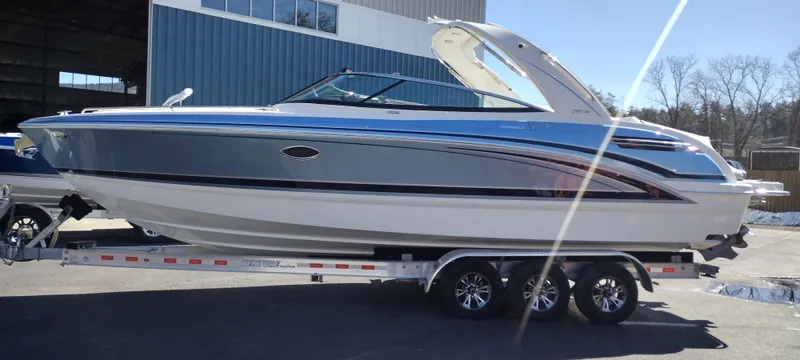 Slide: The Image of 2024 Formula 290 BR boat on trailer, sleek design, parked outdoors. - 5