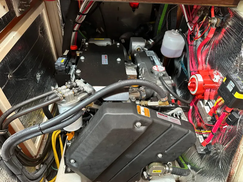 Slide: The Image of Engine compartment of a 1987 Hinckley Sou'wester 42 sailboat, showcasing wiring and components. - 12
